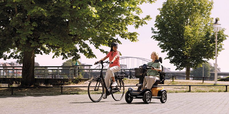 Ausflug mit einem Fahrrad begleitet von einem e-Mobil.